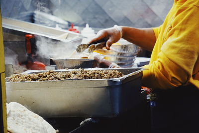 Midsection of man preparing food