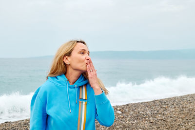 Young woman standing at beach