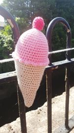 Rear view of pink hat on railing