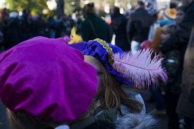 Rear view of people on purple flowering plant