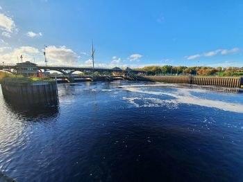 Bridge over river against sky