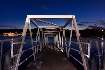 Metallic pier over river at night