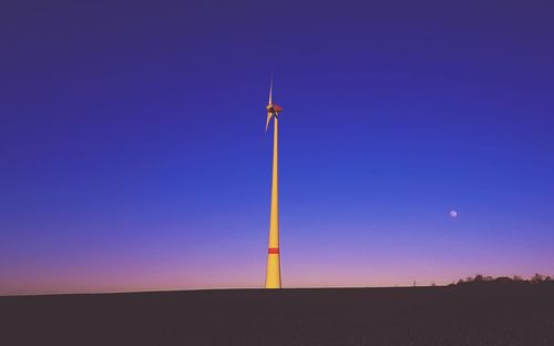 Windmill against clear sky during sunset