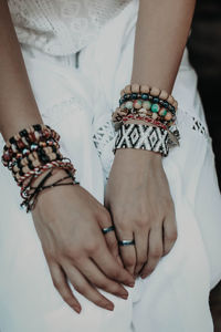 Female hands with hippie beaded bracelets. boho style accessories