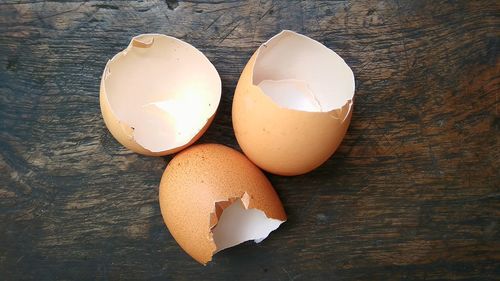 High angle view of broken egg on table