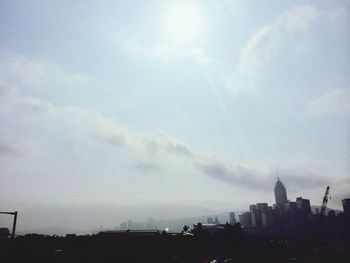 View of cityscape against cloudy sky