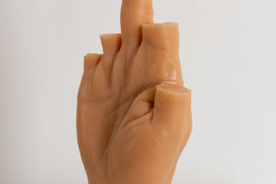 Close-up of human hand against white background