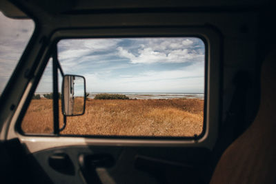 Reflection of sky on side-view mirror