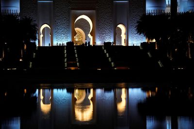 Reflection of building in lake at night