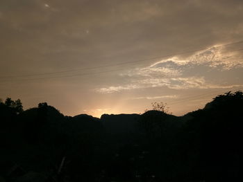 Scenic view of silhouette mountains against sky at sunset