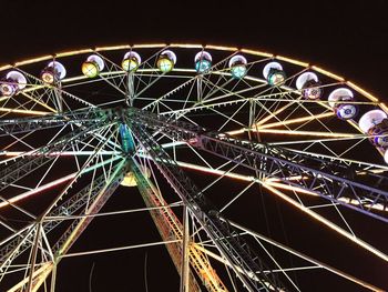 Low angle view of ferris wheel against sky at night