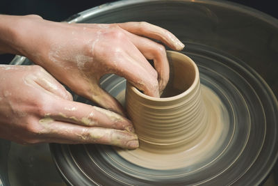 Creating vase of white clay close-up. the sculptor in the workshop makes a jug out of earthenware