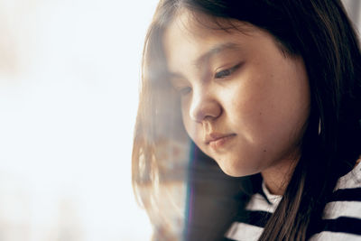 Close-up of young woman looking away