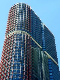 Low angle view of modern building against clear blue sky