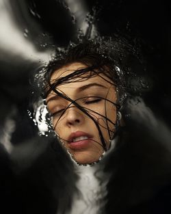 Close-up of young woman with eyes closed in water