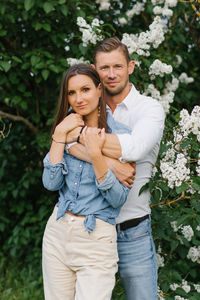 Beautiful young couple in a romantic place, spring blooming lilac garden. happy joyful couple 