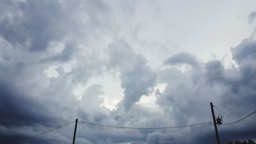 Low angle view of electricity pylon against sky