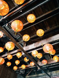 Low angle view of orange hanging lights