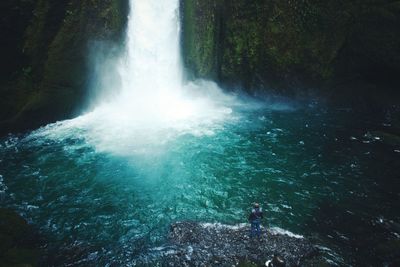 Waterfall amidst rocks at forest