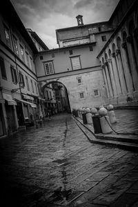 Street amidst buildings in city against sky
