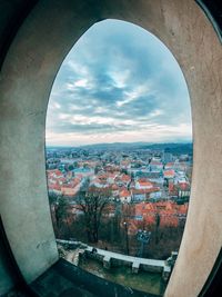 Aerial view of townscape against sky seen through window