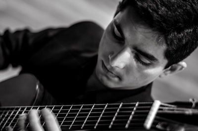 Close-up of man playing guitar