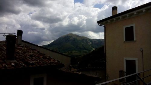 View of house against cloudy sky