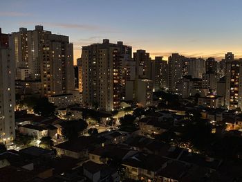 High angle view of illuminated buildings against sky at dusk