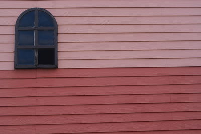 Low angle view of window on wall of building