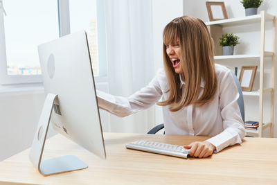 Young woman using laptop at office