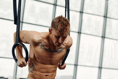 Muscular man exercising at gym