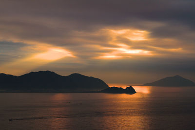 Scenic view of calm sea against cloudy sky