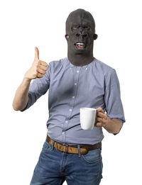 Midsection of man holding coffee cup against white background