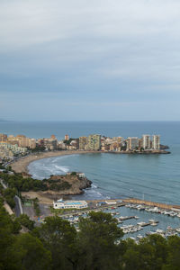 High angle view of sea and cityscape against sky