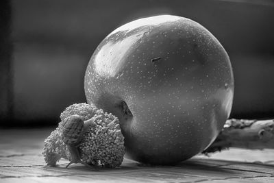 Close-up of pear with snail on table