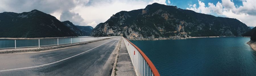 Panoramic view of road by sea against sky