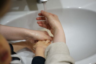 Mom and child washing hands together