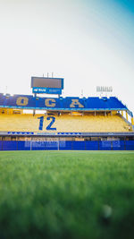 Low angle view of built structure on field against clear sky