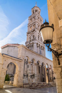 Low angle view of bell tower against sky