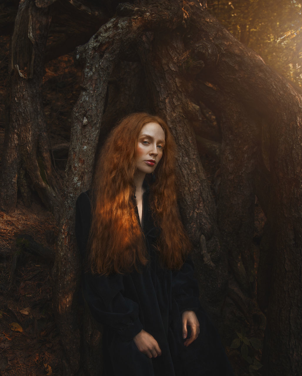 long hair, hairstyle, darkness, one person, women, young adult, portrait, adult, redhead, tree, forest, nature, land, brown hair, looking, leisure activity, clothing, front view, cave, fashion, looking at camera, lifestyles, standing, outdoors, curly hair, waist up, three quarter length, plant, female, contemplation