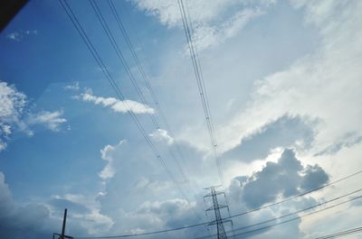 Low angle view of electricity pylon against sky