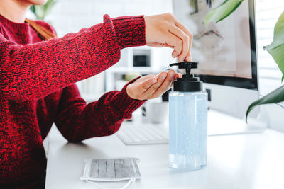 Midsection of woman holding red wine