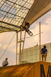 People riding motorcycle against sky