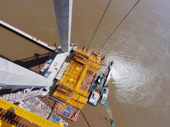 High angle view of buildings by sea against sky