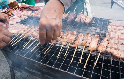 High angle view of man preparing food on barbecue grill