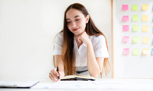 Young woman using laptop at table