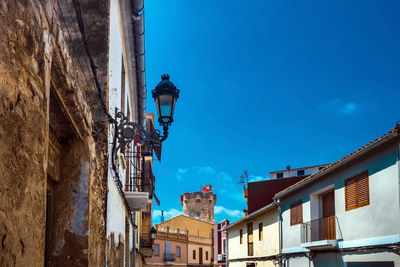 Low angle view of buildings against blue sky