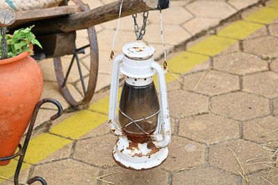 High angle view of lantern hanging on stone