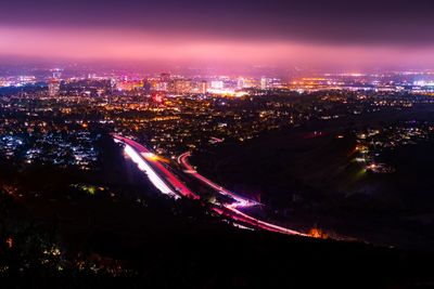 High angle view of illuminated city buildings at night
