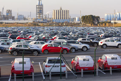 Import of new cars for sale in a parking, automotive industry